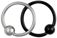 This set of 18 gauge cartilage jewelry includes a plain steel hoop and a Titanium IP plated black hoop. IP (Ion Plating) is a safe and permanent fusion coating process used to enhance the durability, color and shine of body jewelry. Both pieces of jewelry are made with surgical grade 316L Stainless Steel. These captive bead rings have a 5/16" (8 mm) diameter and come with a 3 mm ball. Both pieces of body piercing jewelry are hypoallergenic and nickel free.
